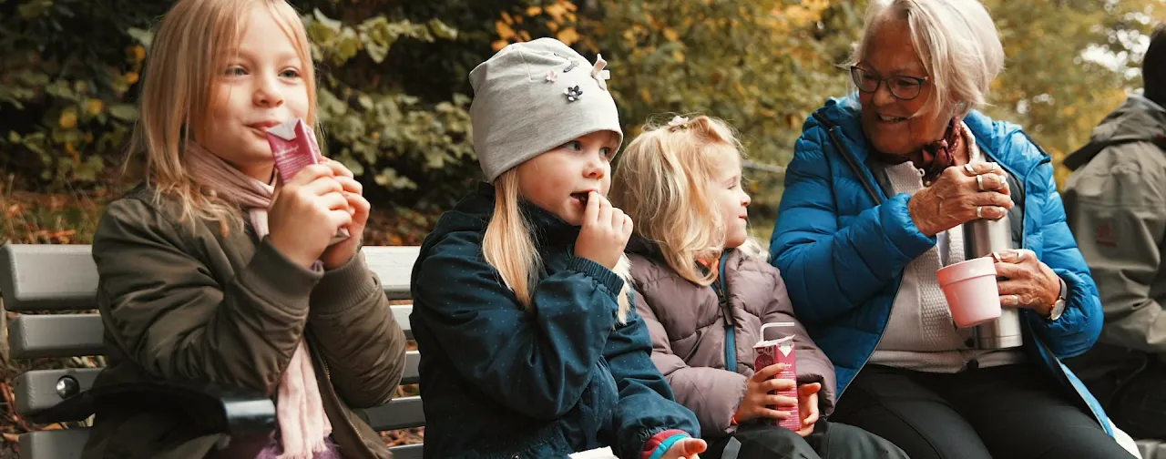 Barn och vuxna njuter av en picknick i Slottsskogen, en av Göteborgs mest barnvänliga platser.