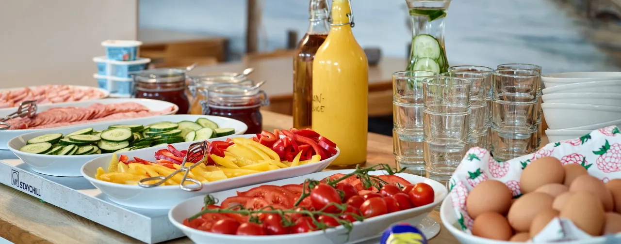 Breakfast buffet at Gothenburg Hostel with eggs, vegetables, juice and cold cuts